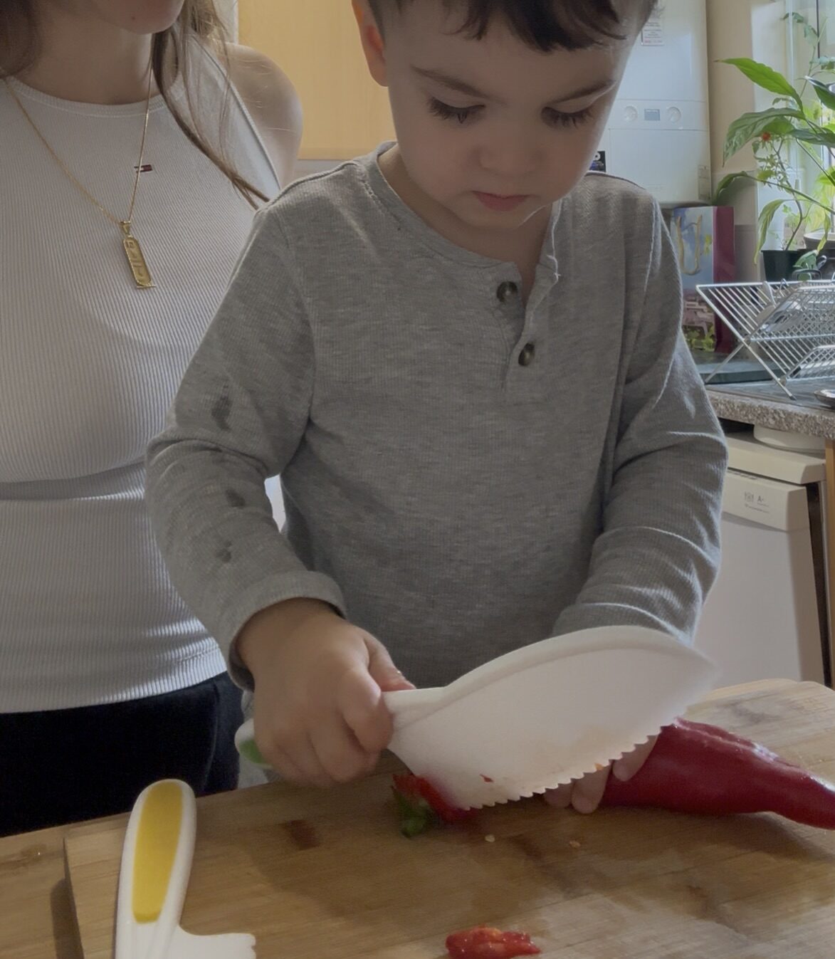 Mum and Child chopping up red pepper with knife